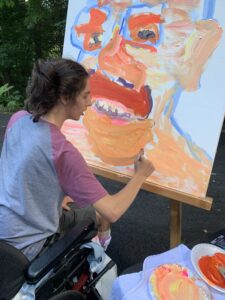 Peter working on large painting of Joe Guarino’s face